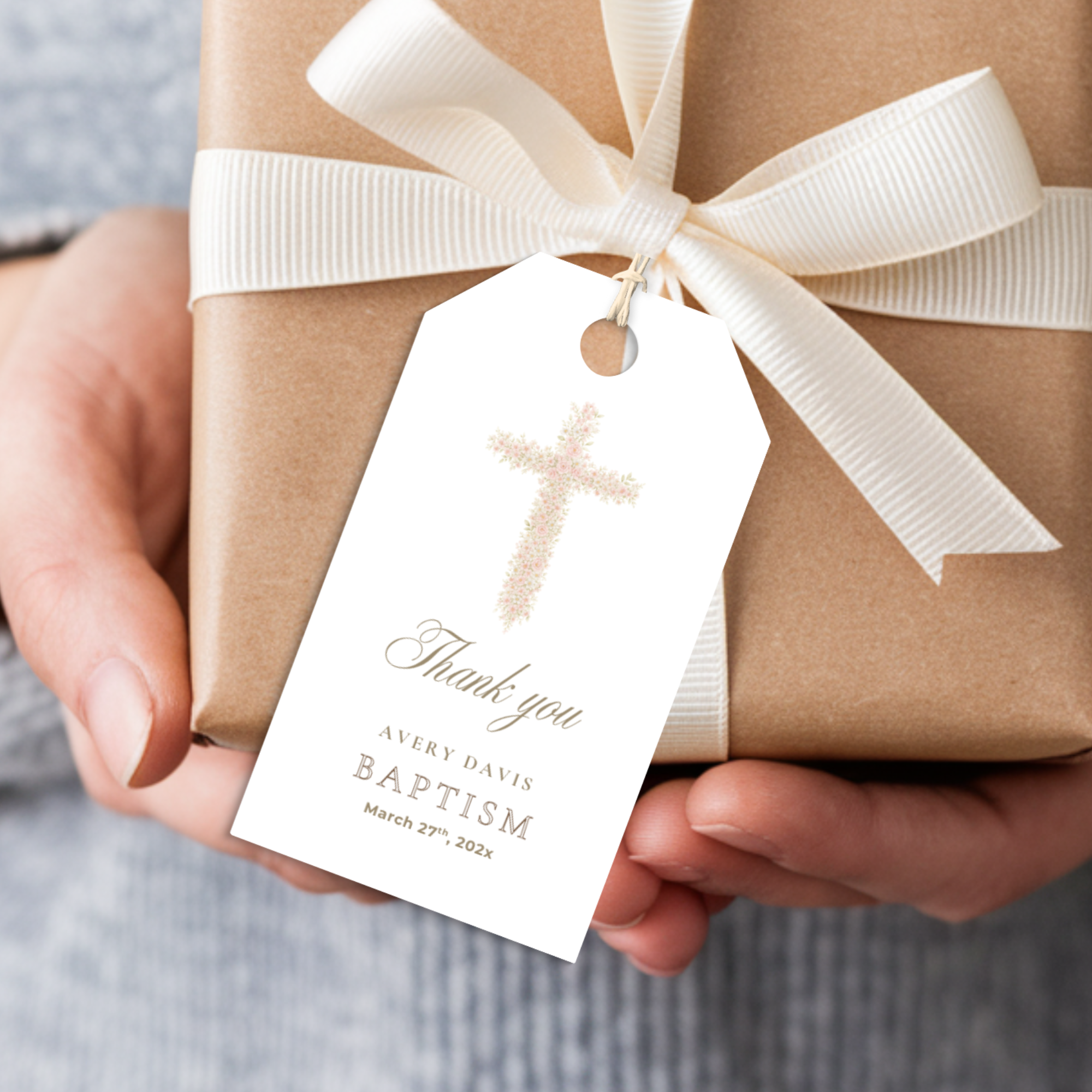 Soft pink floral baptism favor tag with elegant blush floral cross attached to kraft gift packaging