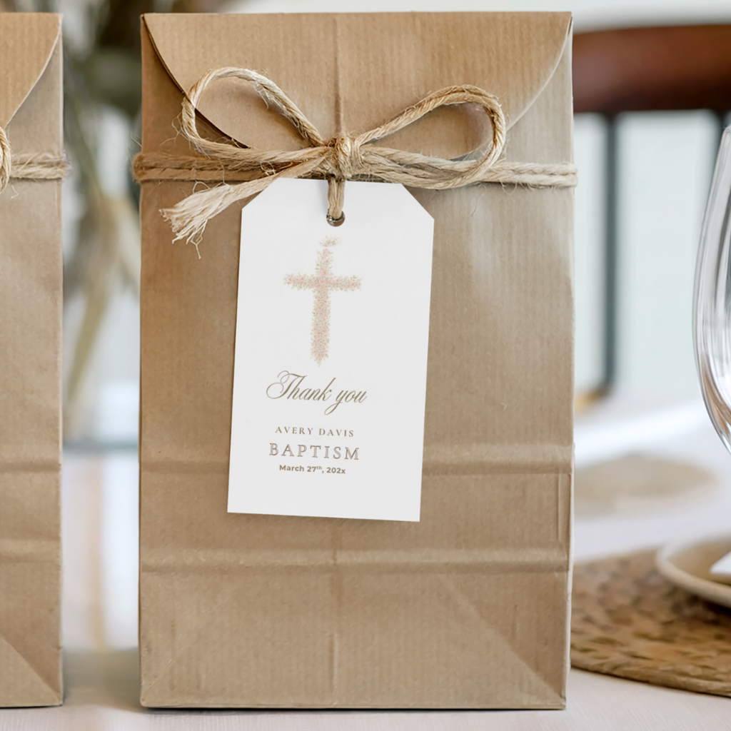 Soft pink floral baptism favor tag with elegant blush floral cross attached to kraft gift packaging