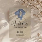 Minimalist first birthday invitation with blue bow illustration and soft neutral background