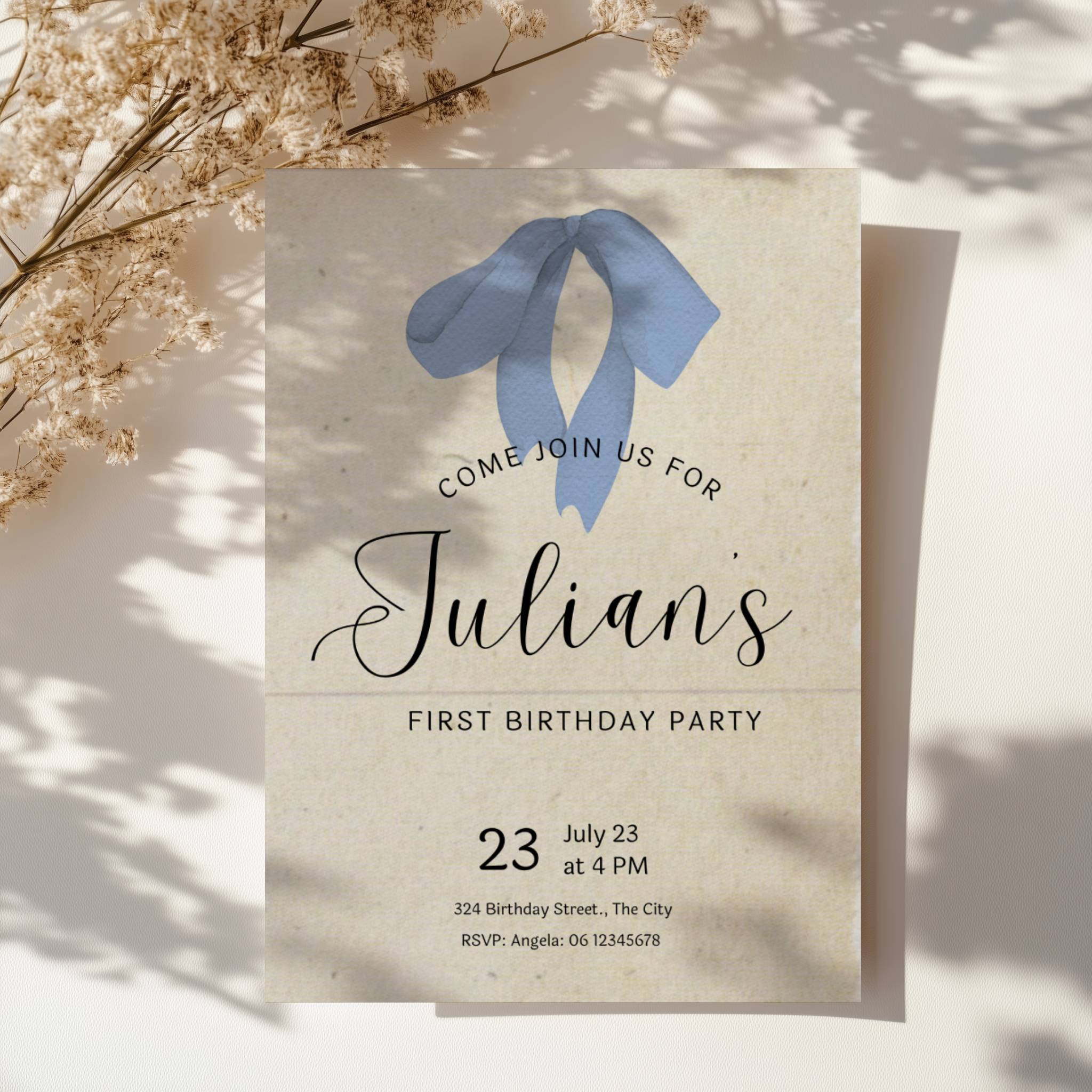 Minimalist first birthday invitation with blue bow illustration and soft neutral background