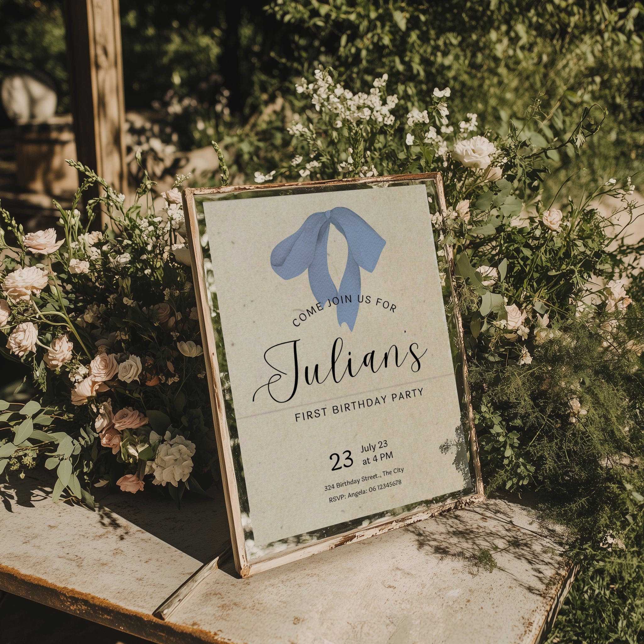 Minimalist first birthday invitation with blue bow illustration and soft neutral background
