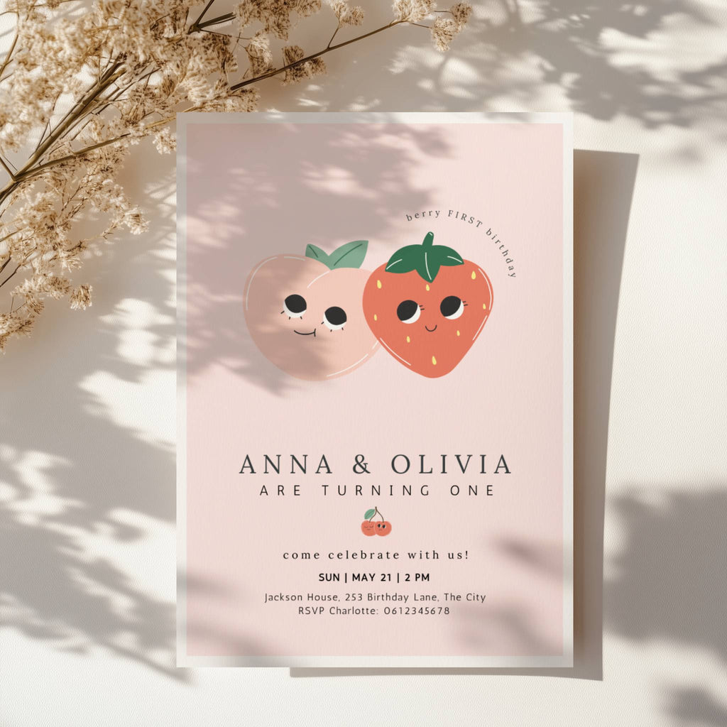 Berry first birthday twin invitation with strawberry and peach illustration and soft pink background
