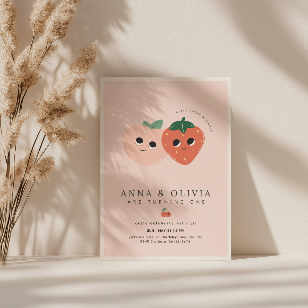 Berry first birthday twin invitation with strawberry and peach illustration and soft pink background