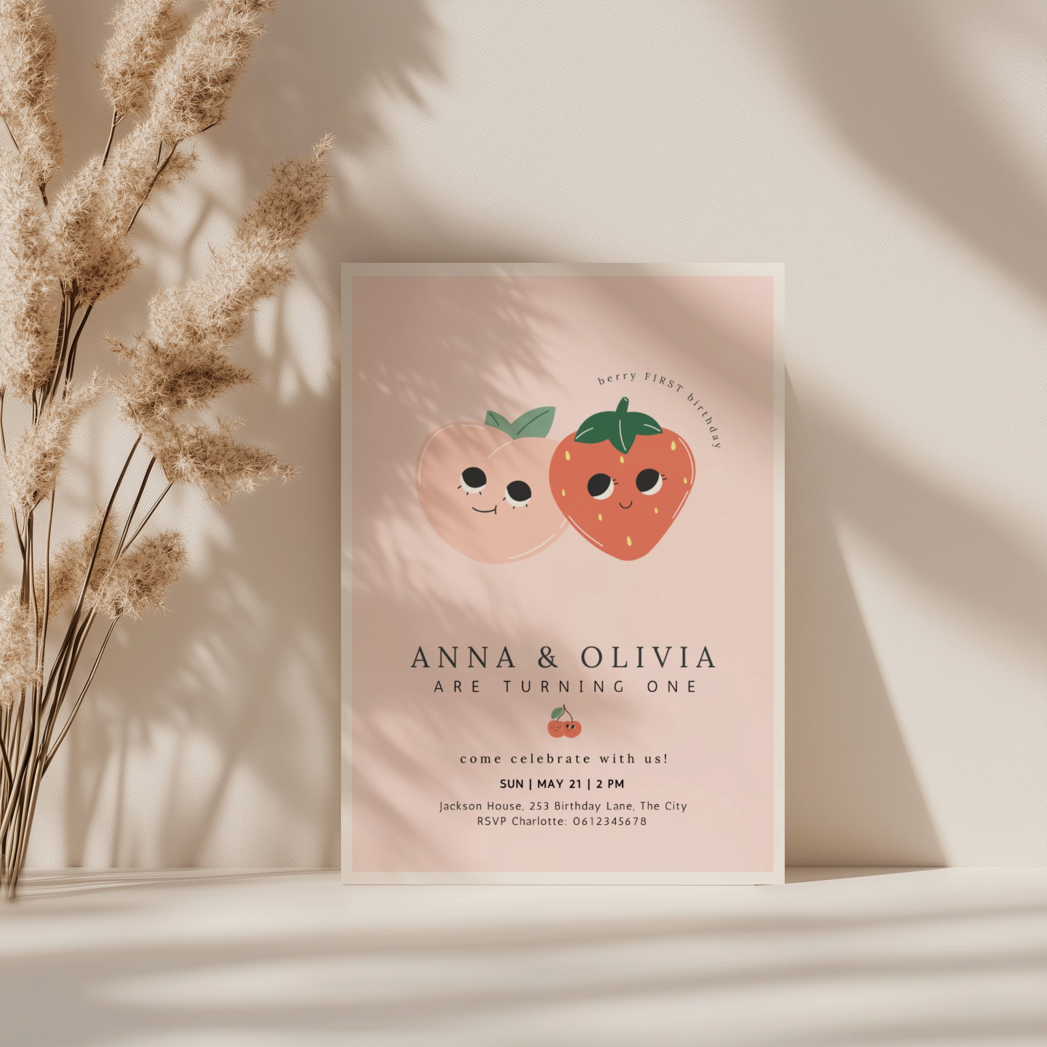 Berry first birthday twin invitation with strawberry and peach illustration and soft pink background