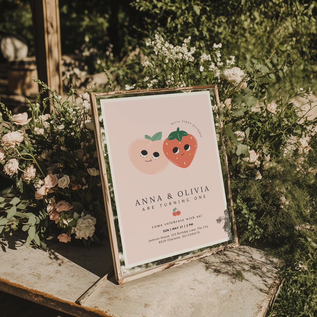 Berry first birthday twin invitation with strawberry and peach illustration and soft pink background