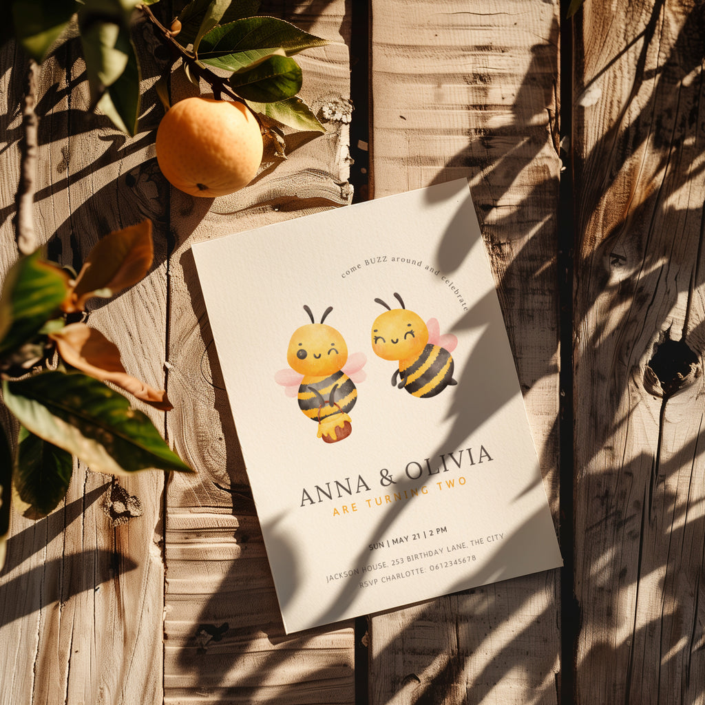 Twin birthday invitation with cute bee illustration and buzz around theme in soft yellow tones