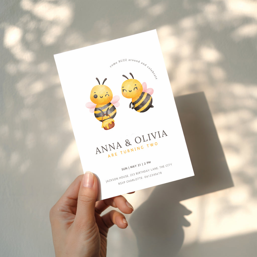 Twin birthday invitation with cute bee illustration and buzz around theme in soft yellow tones