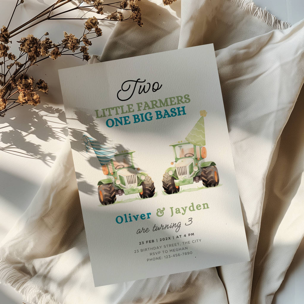 Twin birthday invitation with two green tractors wearing party hats in a cute farm theme design