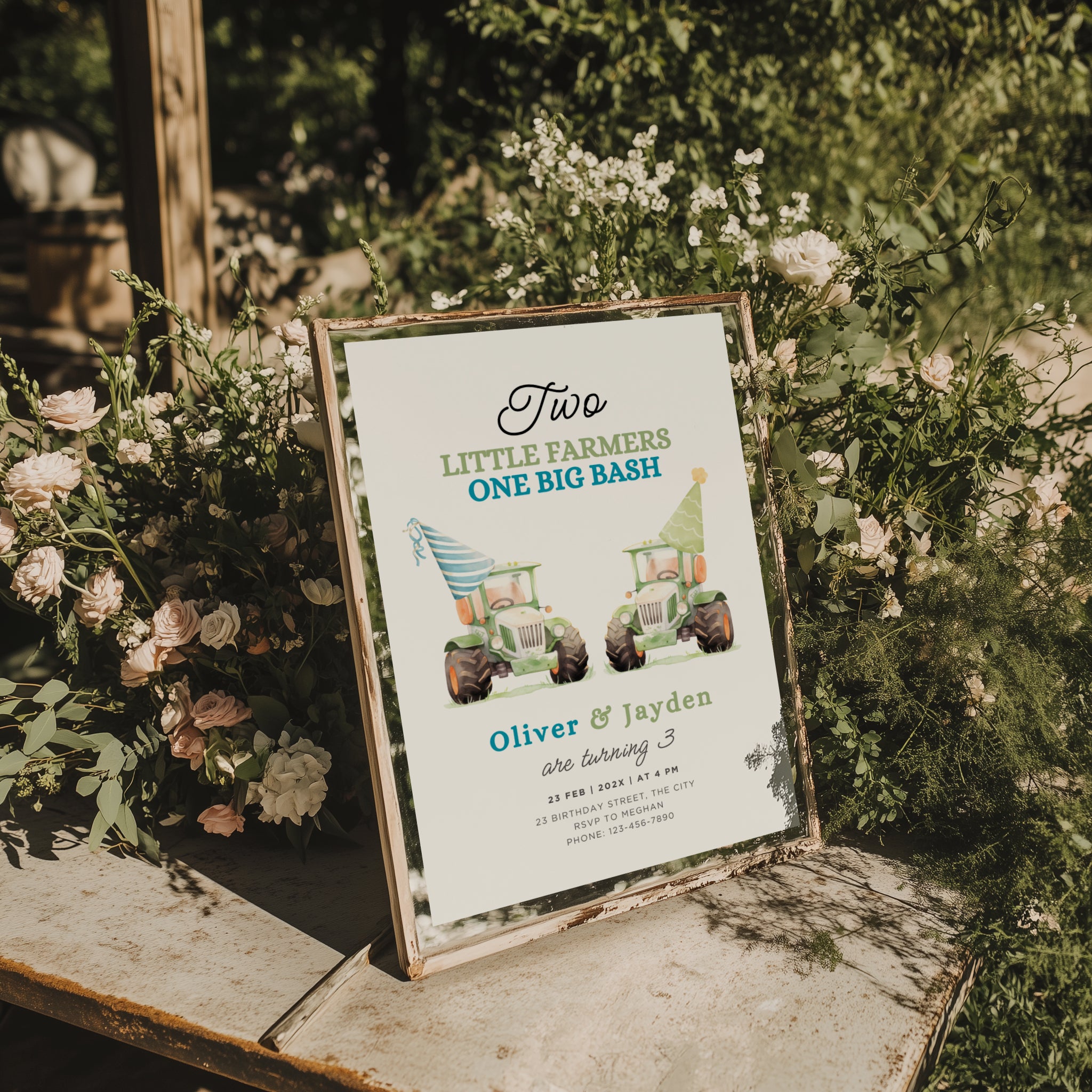 Twin birthday invitation with two green tractors wearing party hats in a cute farm theme design