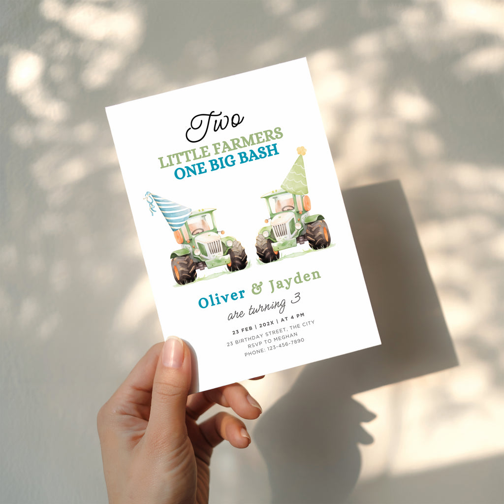Twin birthday invitation with two green tractors wearing party hats in a cute farm theme design