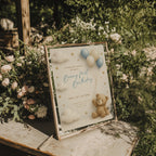Beary first birthday invitation with teddy bear holding balloons in soft neutral colors with clouds and stars for a baby first birthday party