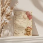 Beary first birthday invitation with teddy bear wearing a bow holding pink balloons in soft pastel colors for a baby girl first birthday party