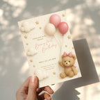 Beary first birthday invitation with teddy bear wearing a bow holding pink balloons in soft pastel colors for a baby girl first birthday party