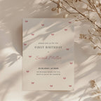 Minimal first birthday invitation with small pink bows and elegant clean design for a baby girl celebration
