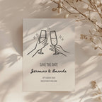 minimalist save the date invitation with champagne glasses toast line drawing and script names