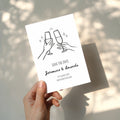 minimalist save the date invitation with champagne glasses toast line drawing and script names