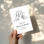 minimalist save the date invitation with champagne glasses toast line drawing and script names
