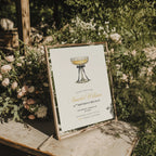 elegant 25th birthday brunch invitation with champagne glass and black bow illustration and gold script text