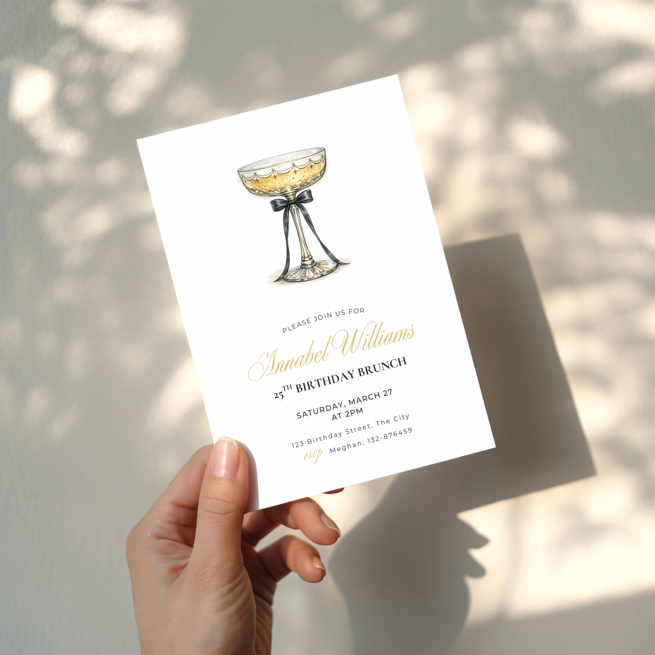 elegant 25th birthday brunch invitation with champagne glass and black bow illustration and gold script text