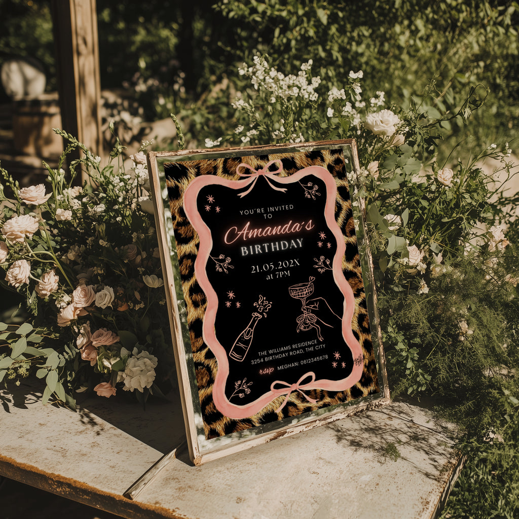 cheetah print birthday invitation with pink ribbon border and black center design