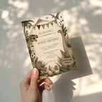 Editable vintage dinosaur adventure birthday invitation featuring hand illustrated prehistoric dinosaurs in neutral earthy tones Canva template