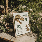 Editable dinosaur fossil birthday invitation featuring a realistic T-Rex skull and prehistoric footprints Canva template