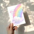 Editable pastel rainbow birthday invitation featuring a watercolor rainbow, fluffy clouds and soft pastel colors Canva template