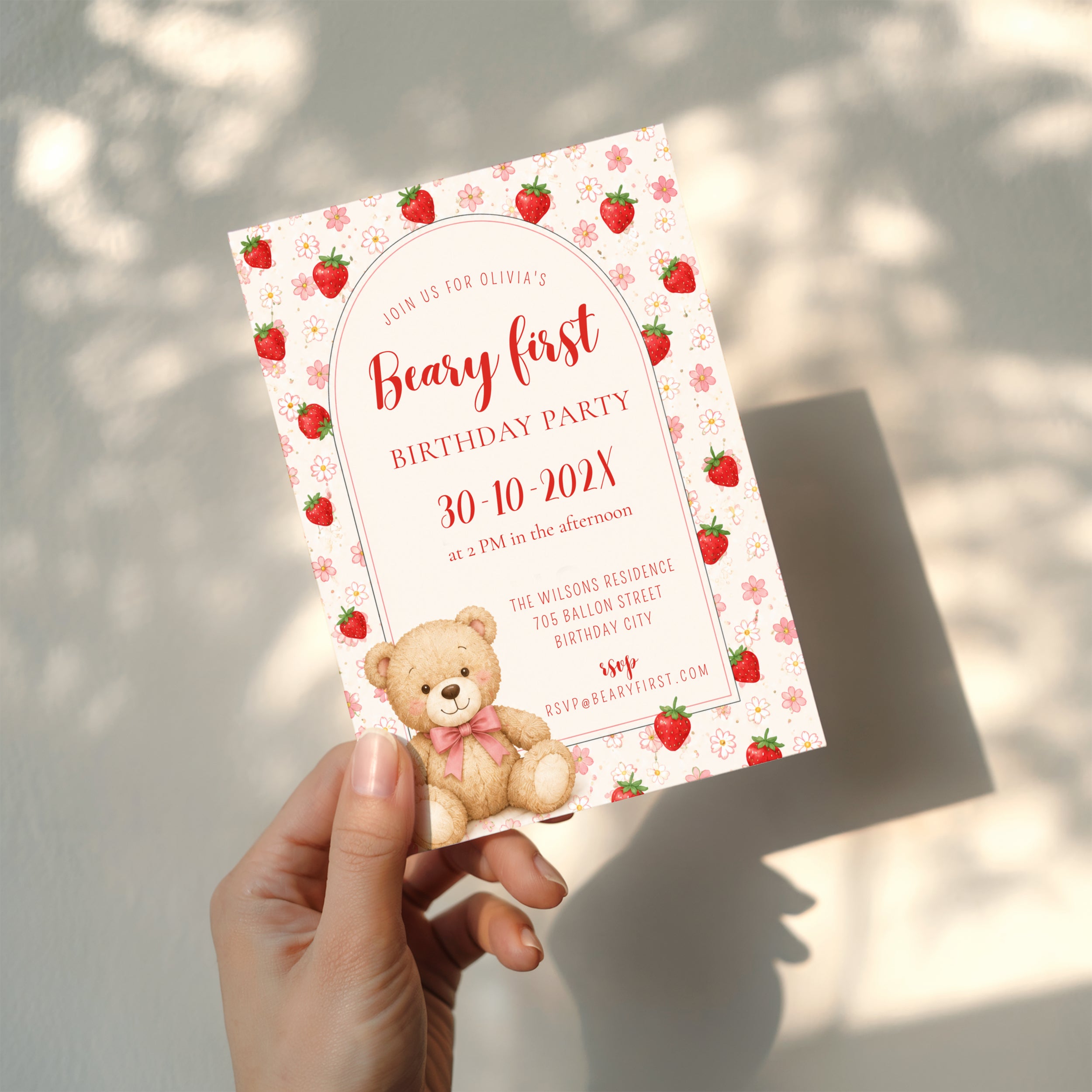 Editable Berry & Beary First birthday invitation with a teddy bear, strawberries, pink flowers, and an elegant arched design for a girl's first birthday party.