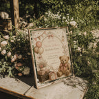Vintage teddy bear birthday invitation with blush balloons, antique suitcases, delicate florals, and a soft storybook watercolor design for a child's birthday celebration.