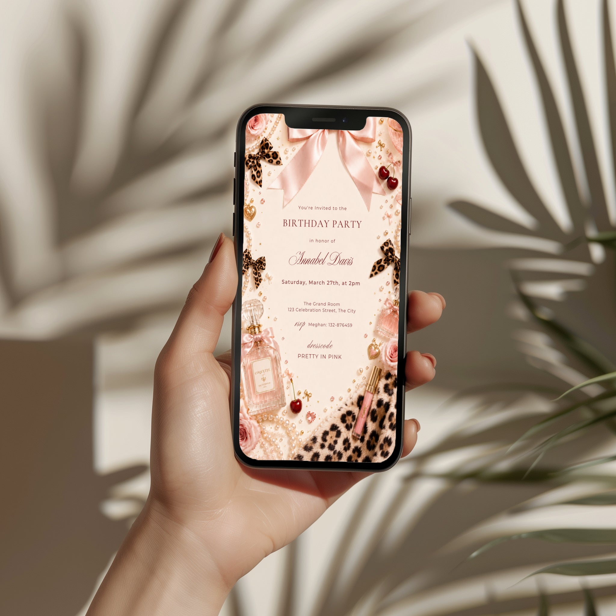 Coquette birthday party invitation featuring pink satin bows, pearls, perfume bottles, cherries, roses, and leopard print accents in an elegant blush aesthetic.