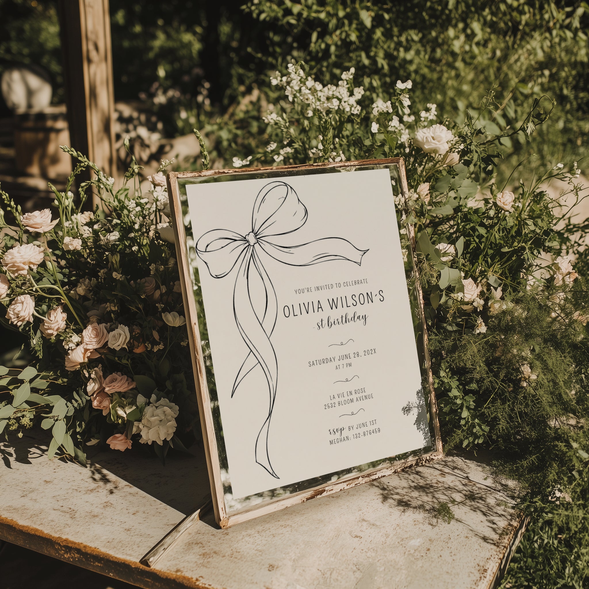 Minimalist black bow first birthday invitation with a hand-drawn ribbon, elegant black typography, and a clean white monochrome layout.