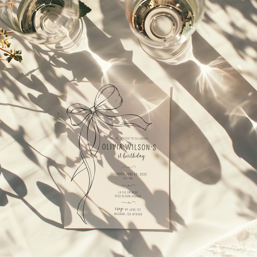Minimalist black bow first birthday invitation with a hand-drawn ribbon, elegant black typography, and a clean white monochrome layout.