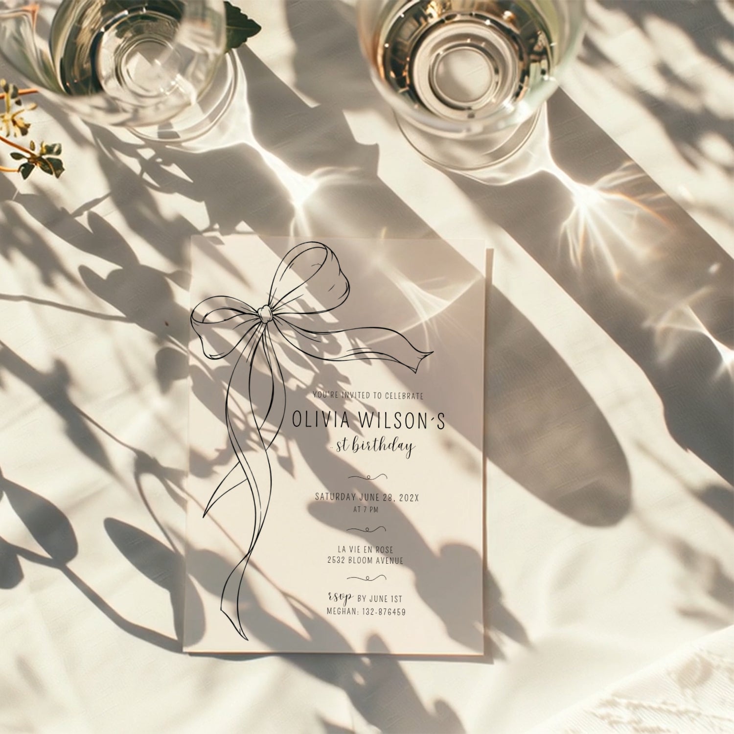 Minimalist black bow first birthday invitation with a hand-drawn ribbon, elegant black typography, and a clean white monochrome layout.