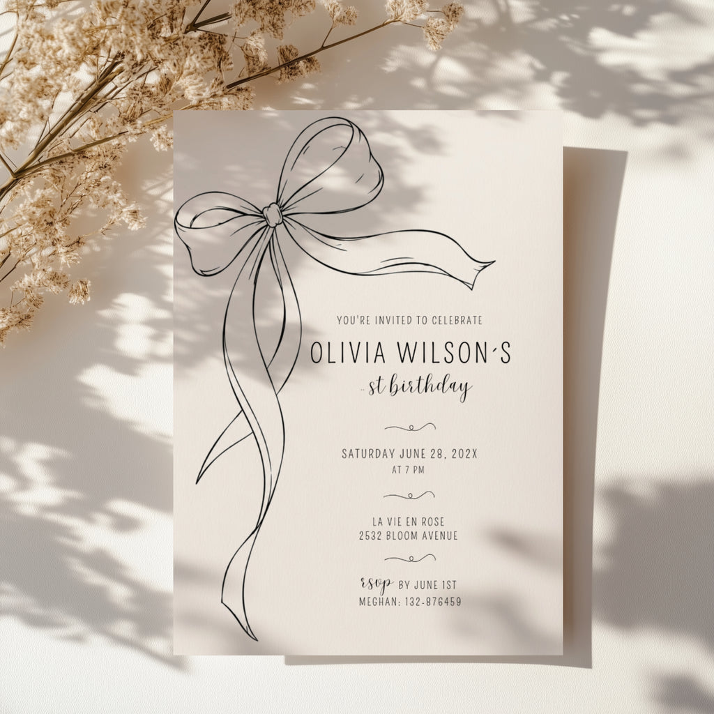 Minimalist black bow first birthday invitation with a hand-drawn ribbon, elegant black typography, and a clean white monochrome layout.