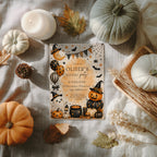 Watercolor Halloween birthday party invitation with a cute ghost, orange pumpkins, witch hats, bats, balloons, and a bubbling black cauldron.