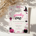 Spooky One first birthday girl invitation in pink and black with cute ghost, witch hat, spider, lollipop, pink pumpkin and bubbling Halloween cauldron illustrations.
