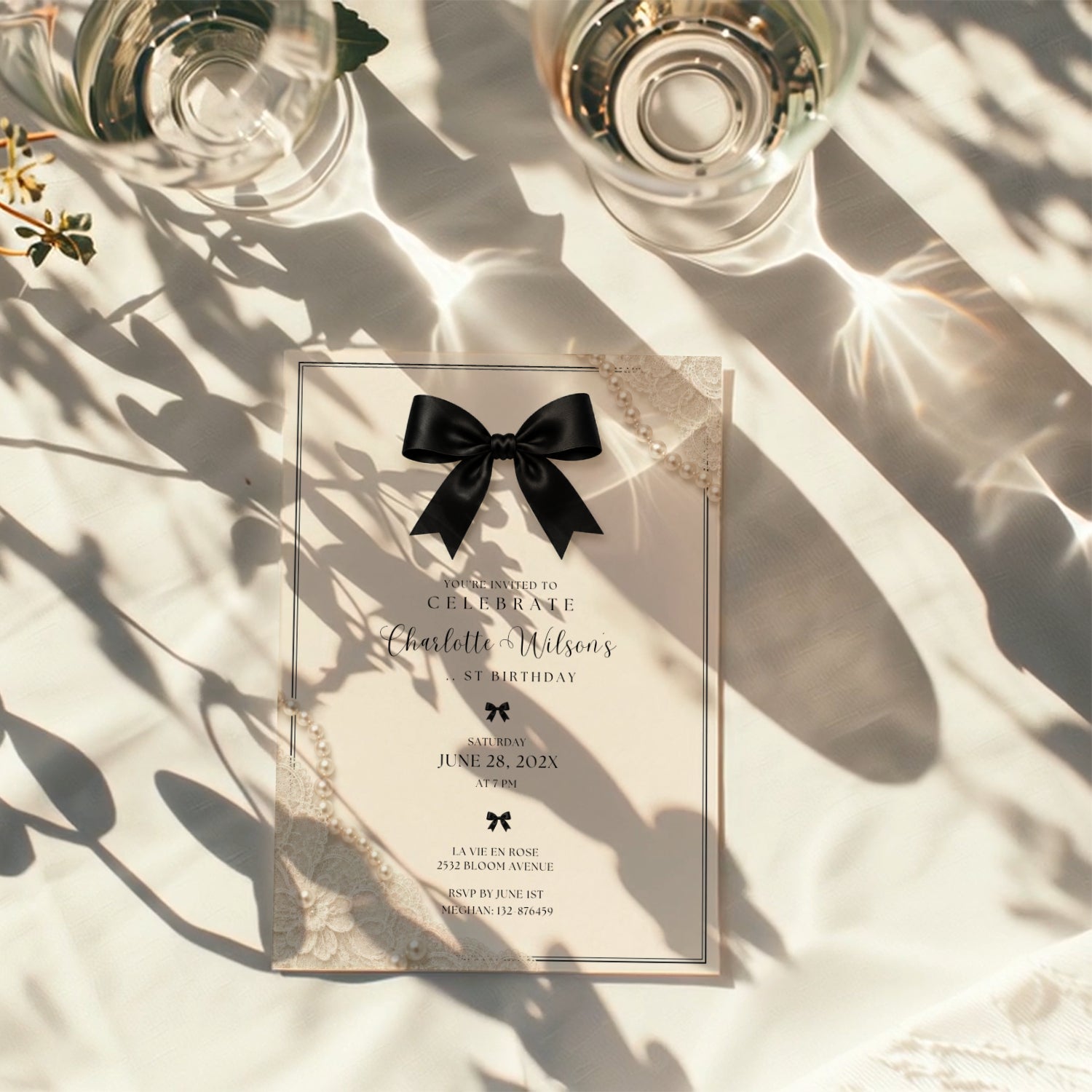 Elegant black bow birthday invitation with ivory background, pearl details and delicate vintage inspired lace accents.