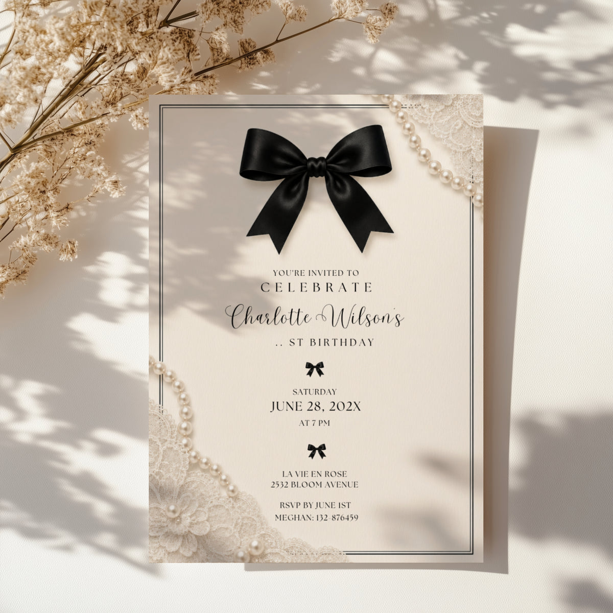 Elegant black bow birthday invitation with ivory background, pearl details and delicate vintage inspired lace accents.