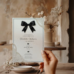 Elegant black bow birthday invitation with ivory background, pearl details and delicate vintage inspired lace accents.