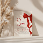 first birthday invitation with red bow and elegant gold accent design
