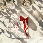 first birthday invitation with red bow and elegant gold accent design
