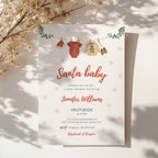 santa baby shower invitation with clothesline illustration and winter snowflake background