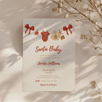 santa baby shower invitation with red bows and watercolor baby clothesline illustration