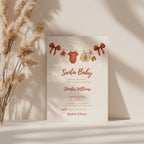 santa baby shower invitation with red bows and watercolor baby clothesline illustration