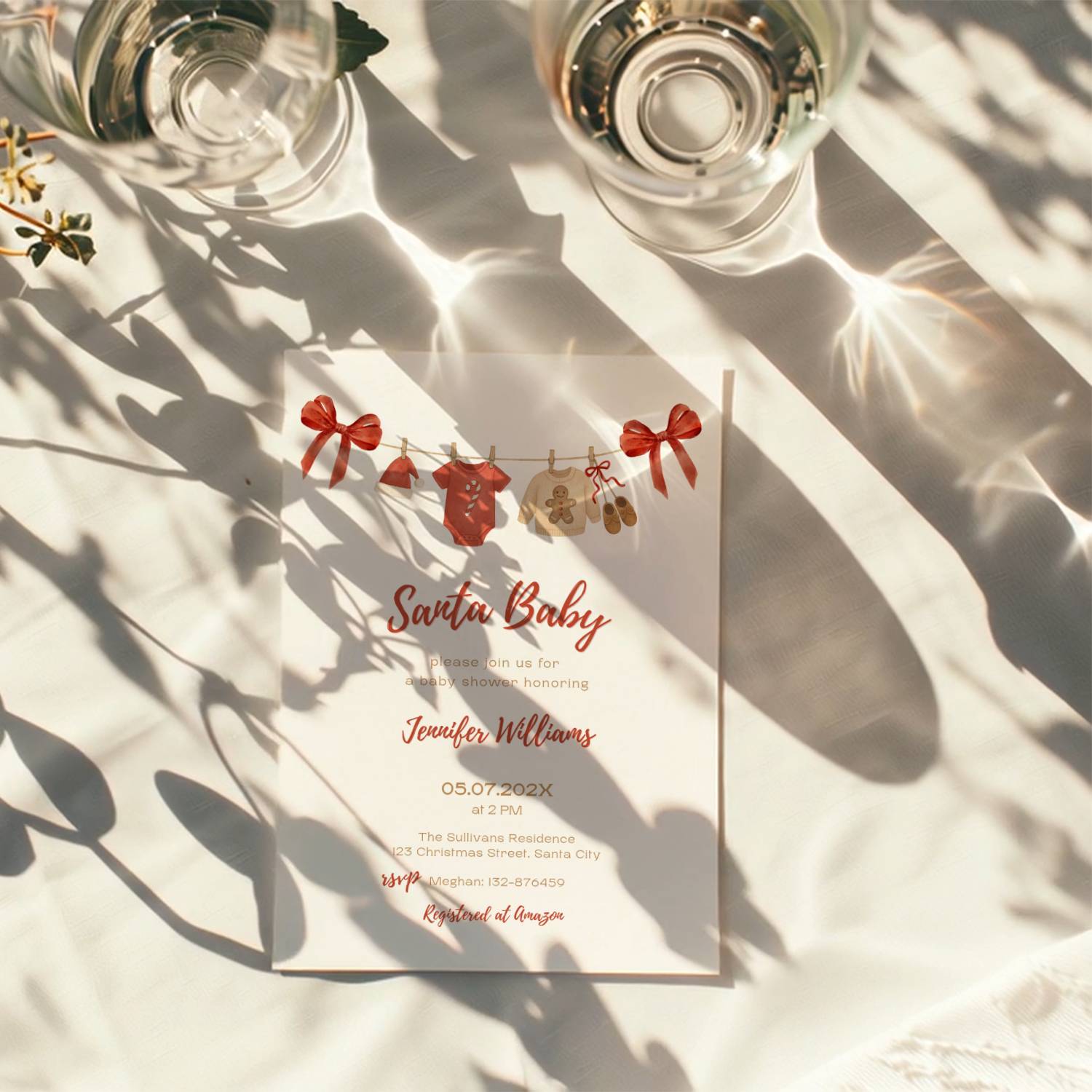 santa baby shower invitation with red bows and watercolor baby clothesline illustration